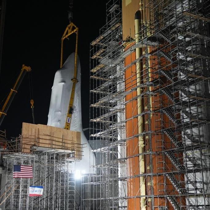 Space shuttle Endeavour hoisted for display in launch configuration at Los Angeles science museum